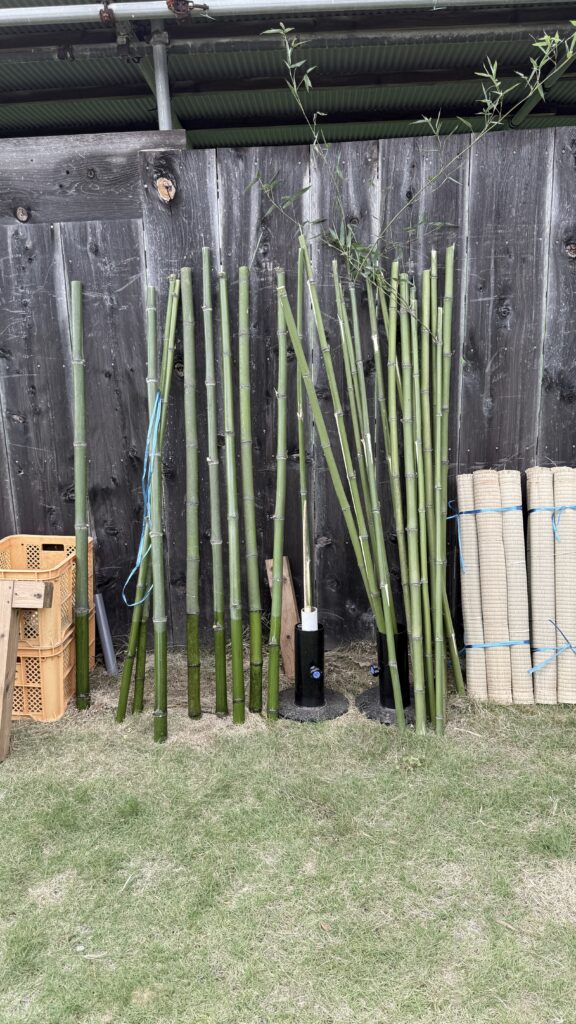 Bamboo poles and rolled mats prepared for sword practice.
